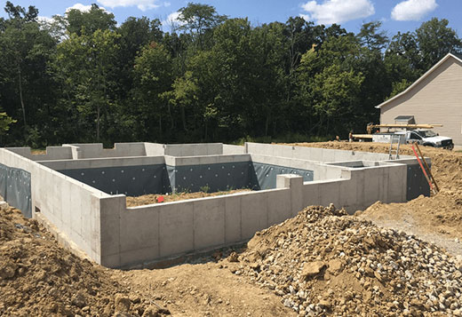 poured concrete walls vs block cost